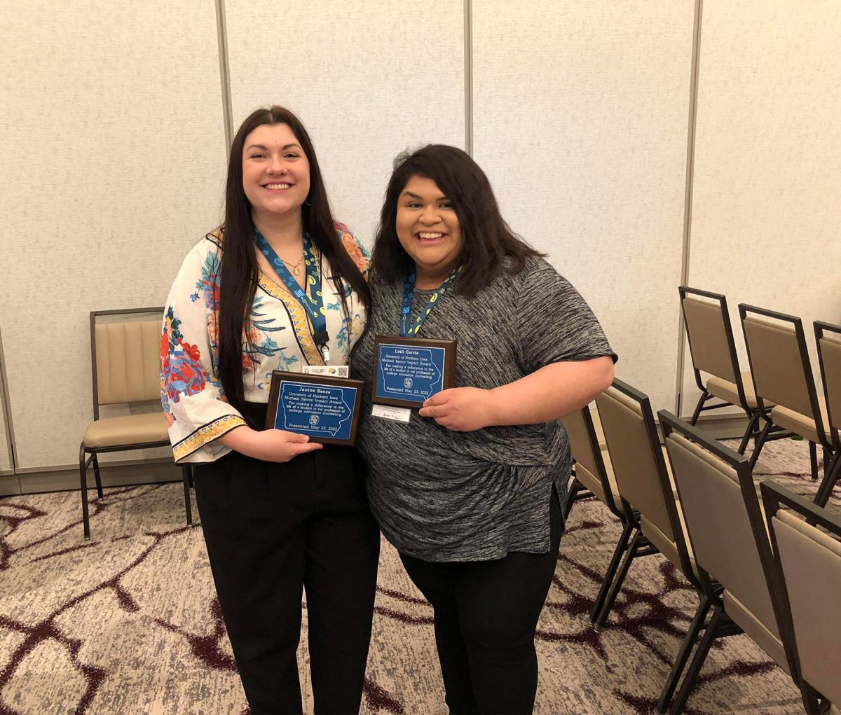 Janine Baeza and Lesli Garcia holding their Michael Barron Impact Awards