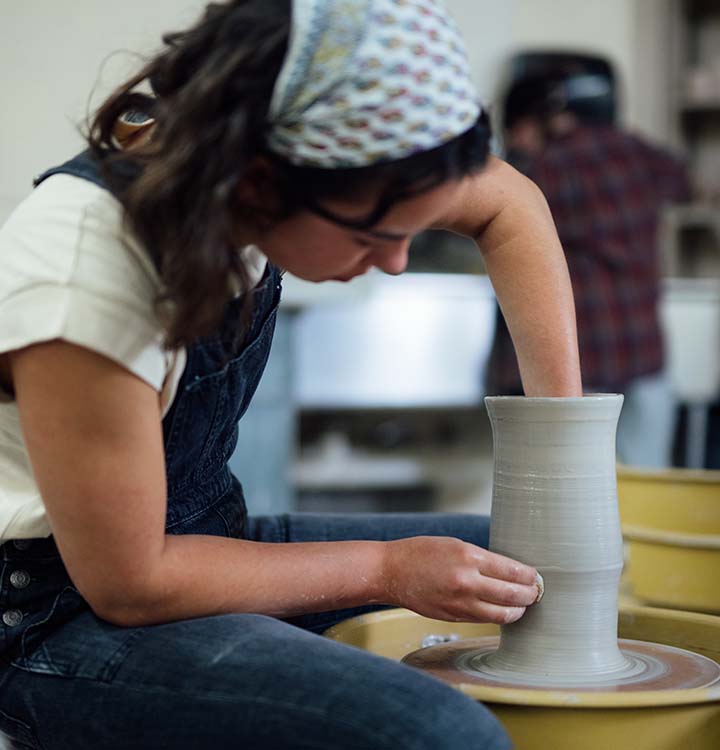Anna Gilbreath on pottery wheel 