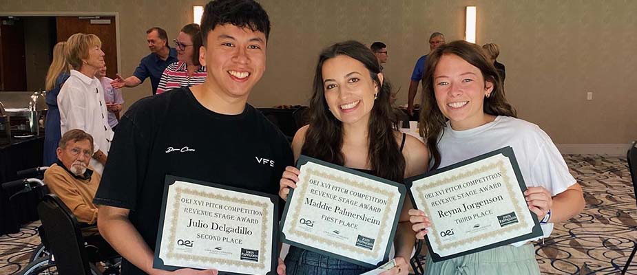 UNI Students holding their awards from OEI