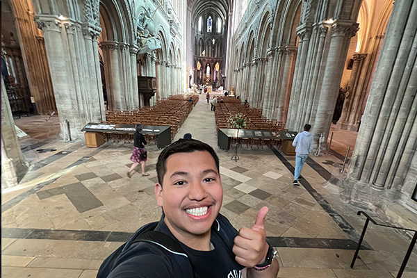 JuanDaniel poses inside of Notre Dame Cathedral