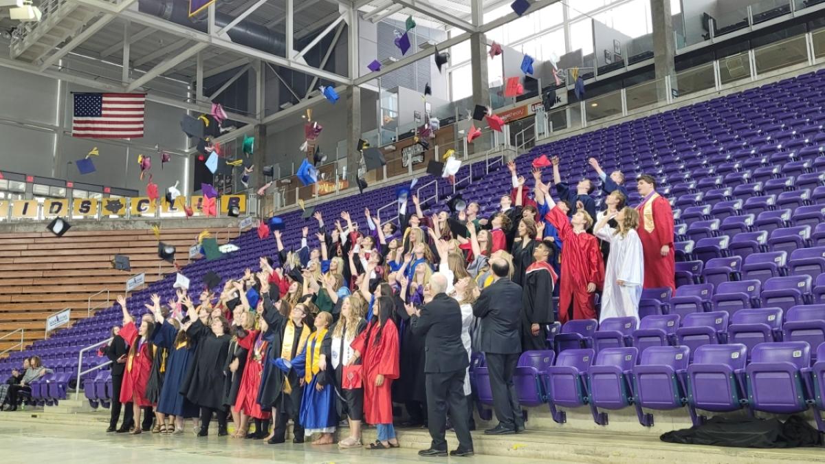 Best of Class students throw their graduation caps in the air