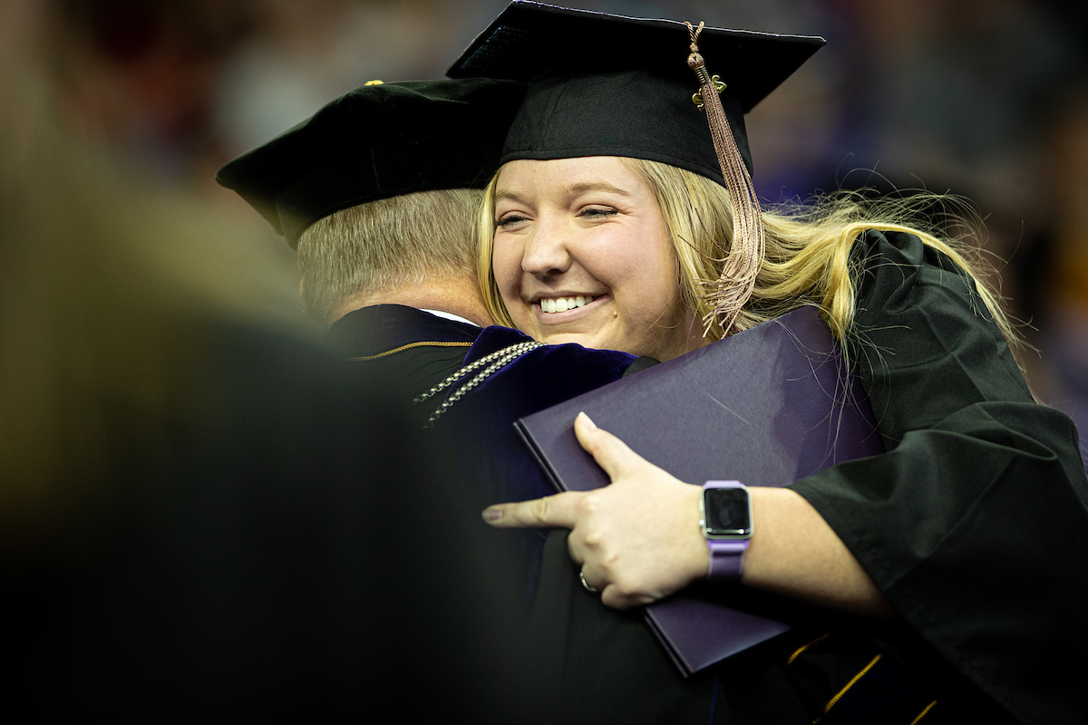 UNI graduate hugging President Nook at Commencement