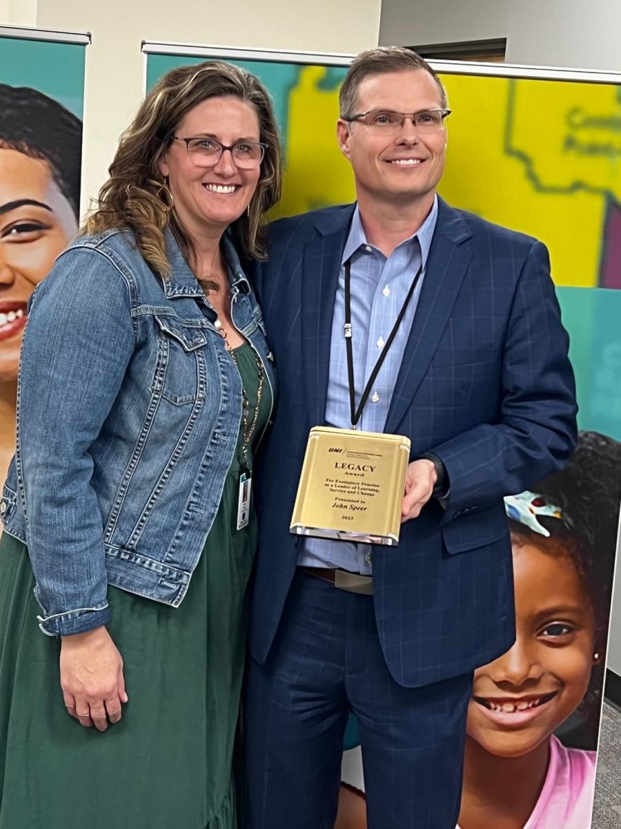 John Speer holding his award with his wife