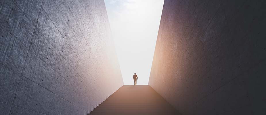 Person walking up stairs into sunlight