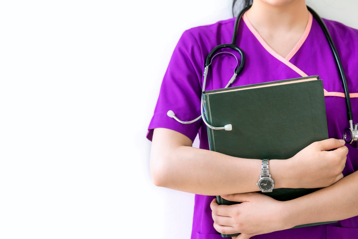 Woman wearing purple scrubs