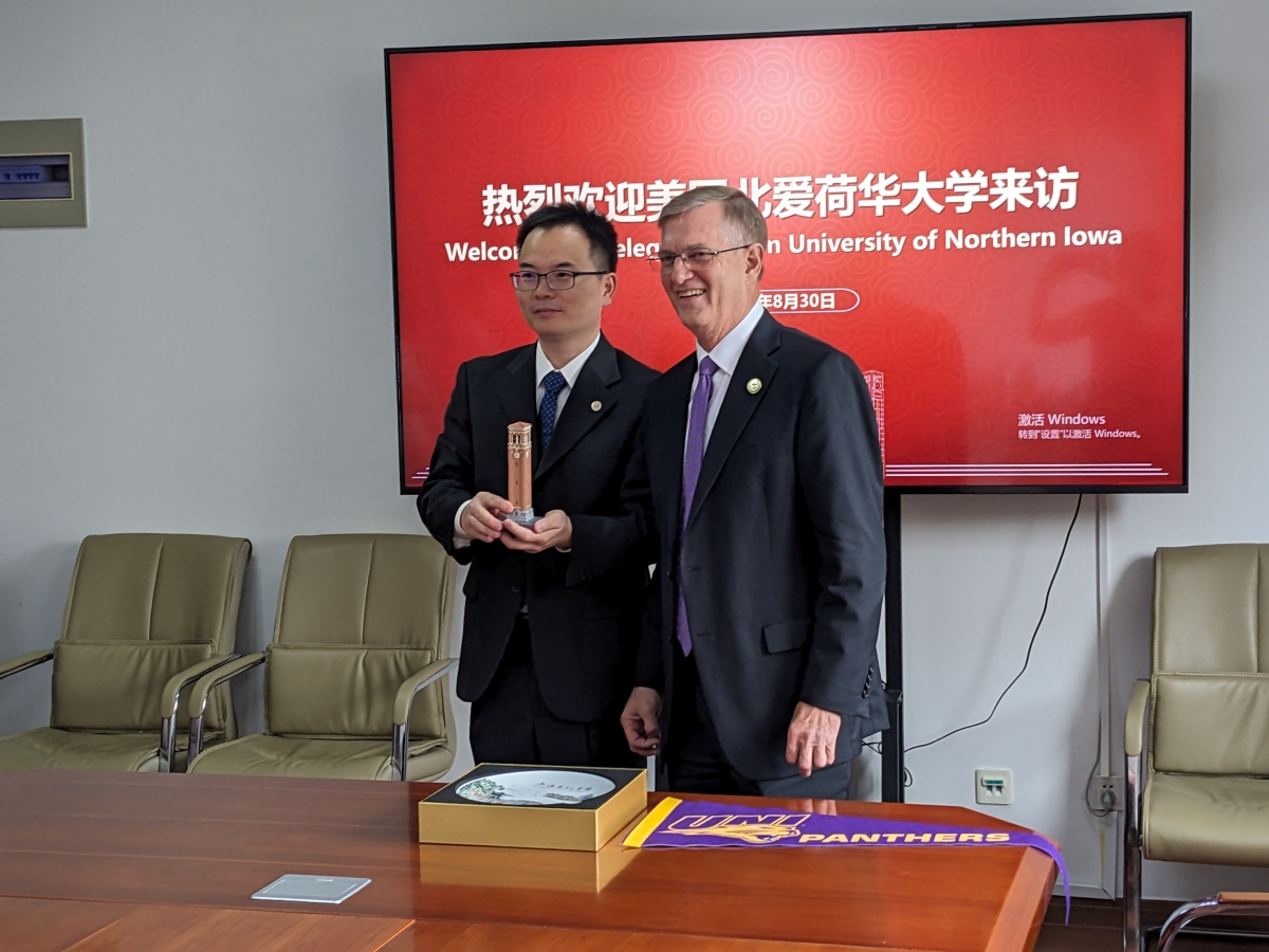 President Nook sharing a small Campanile statue with Vice President of Shanghai Dianji University, Dr. Junjie Yang