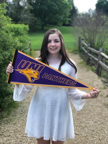 Brittany Costello holding a UNI flag