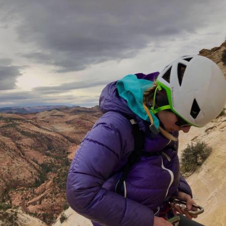 Hannah Lang climbing up a mountain