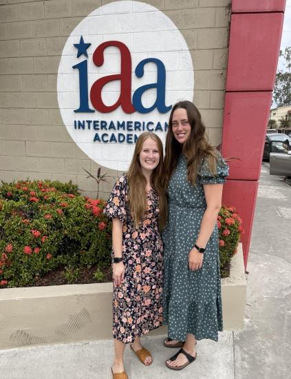 Emmalee Fannon and Cassey Bly in front of the InterAmerican Academy