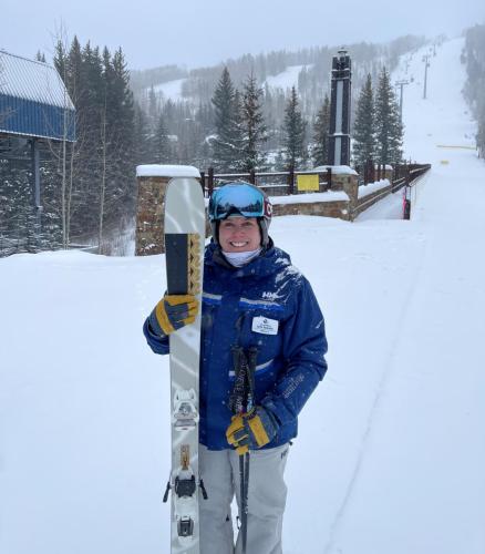 Beth Howard with skis on a snowy mountain