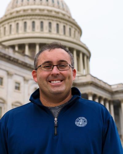 Josh Wilson in front of Capitol Hill