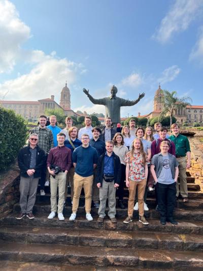 Jazz Band One standing in front of statue of Nelson Mandela