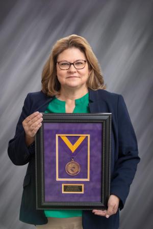 Shelley O'Connell holding her Presidential Medallion