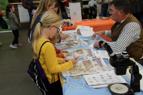 Children excavate simulated rocks at the Cedar Valley STEM Festival