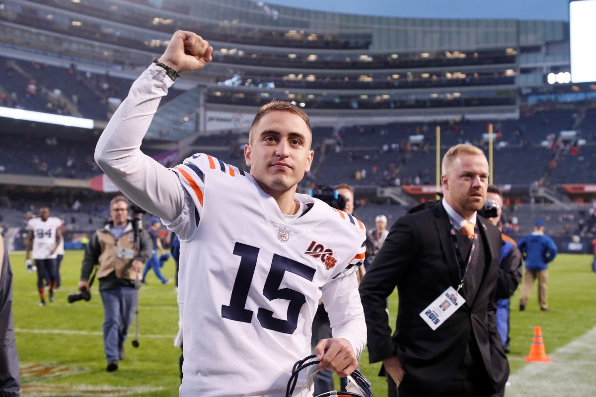 Ben Schmitz on football field next to Chicago Bears player