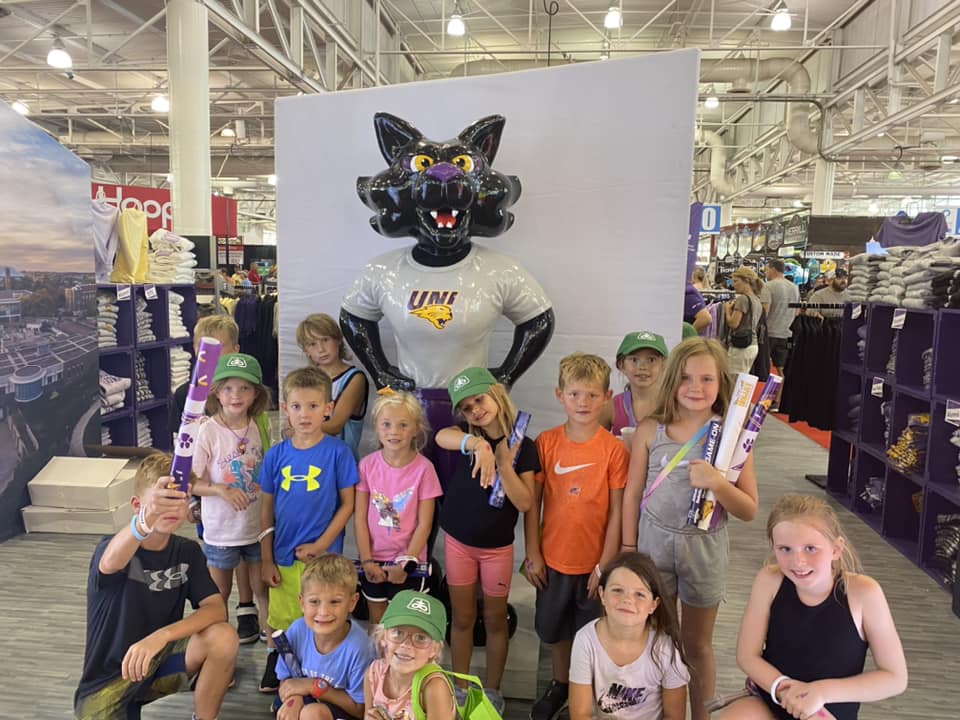 Day Camp Adventures students pose with statue of TC the mascot at the Iowa State Fair