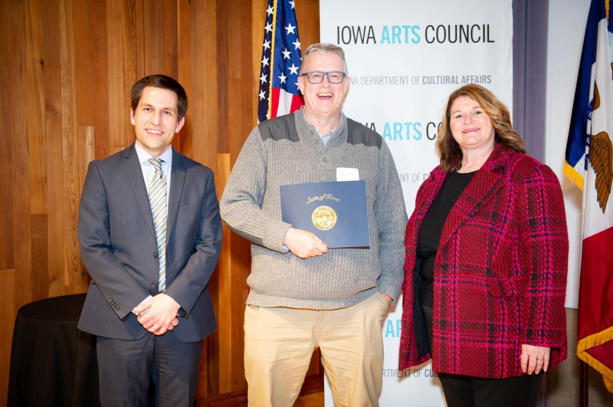 Steve Carignan holding award