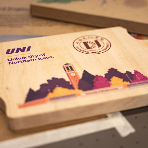 Wooden Iowa objects stamped with UNI campus illustration