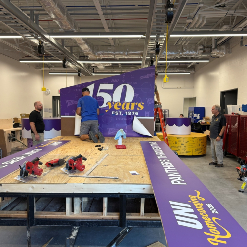 Students assembling UNI Homecoming float