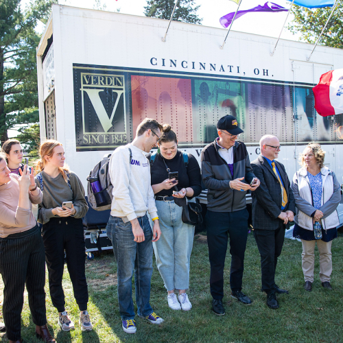 UNI community members passing ingots of brass