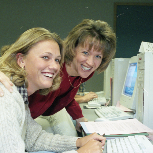 October 1999: Wilson helping a student in the computer lab.