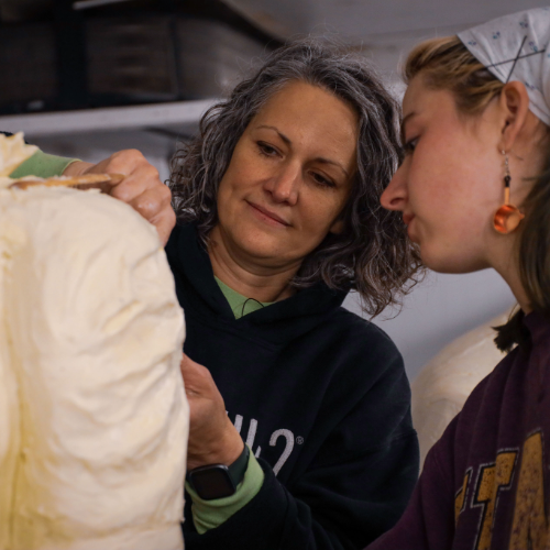 Sarah and Hannah working on the Kurt Warner sculpture. 