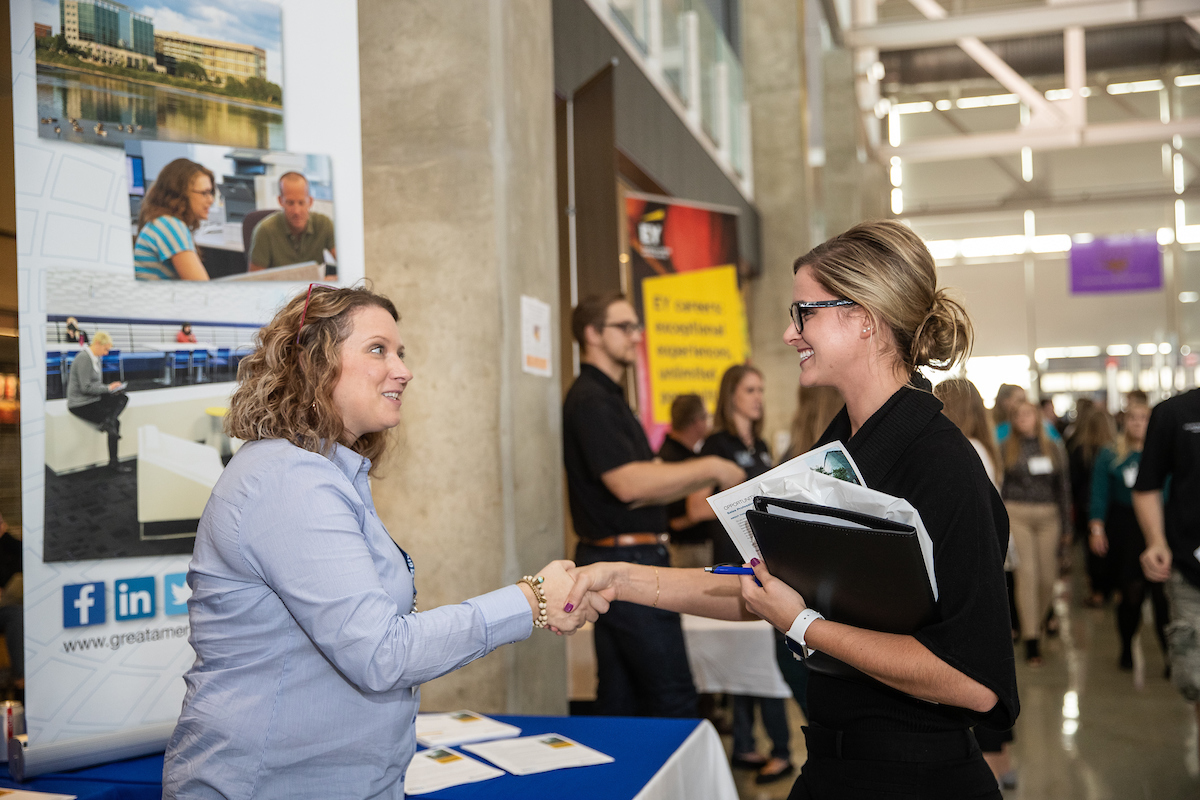 Student shaking hands with prospective employer at UNI career fair