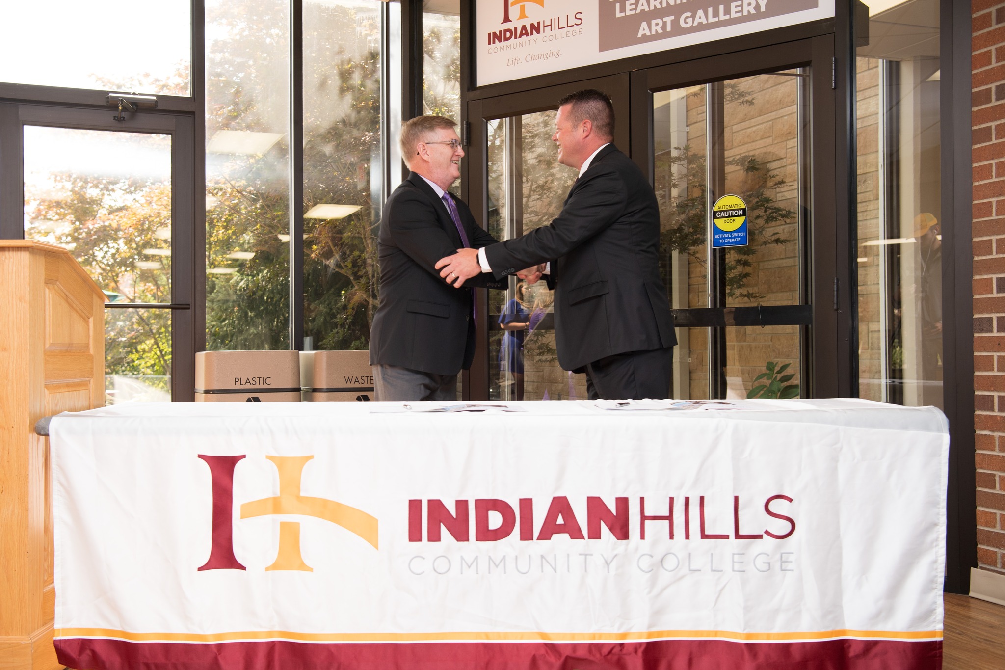 UNI President Mark Nook and Indian Hills President Matt Thompson shaking hands