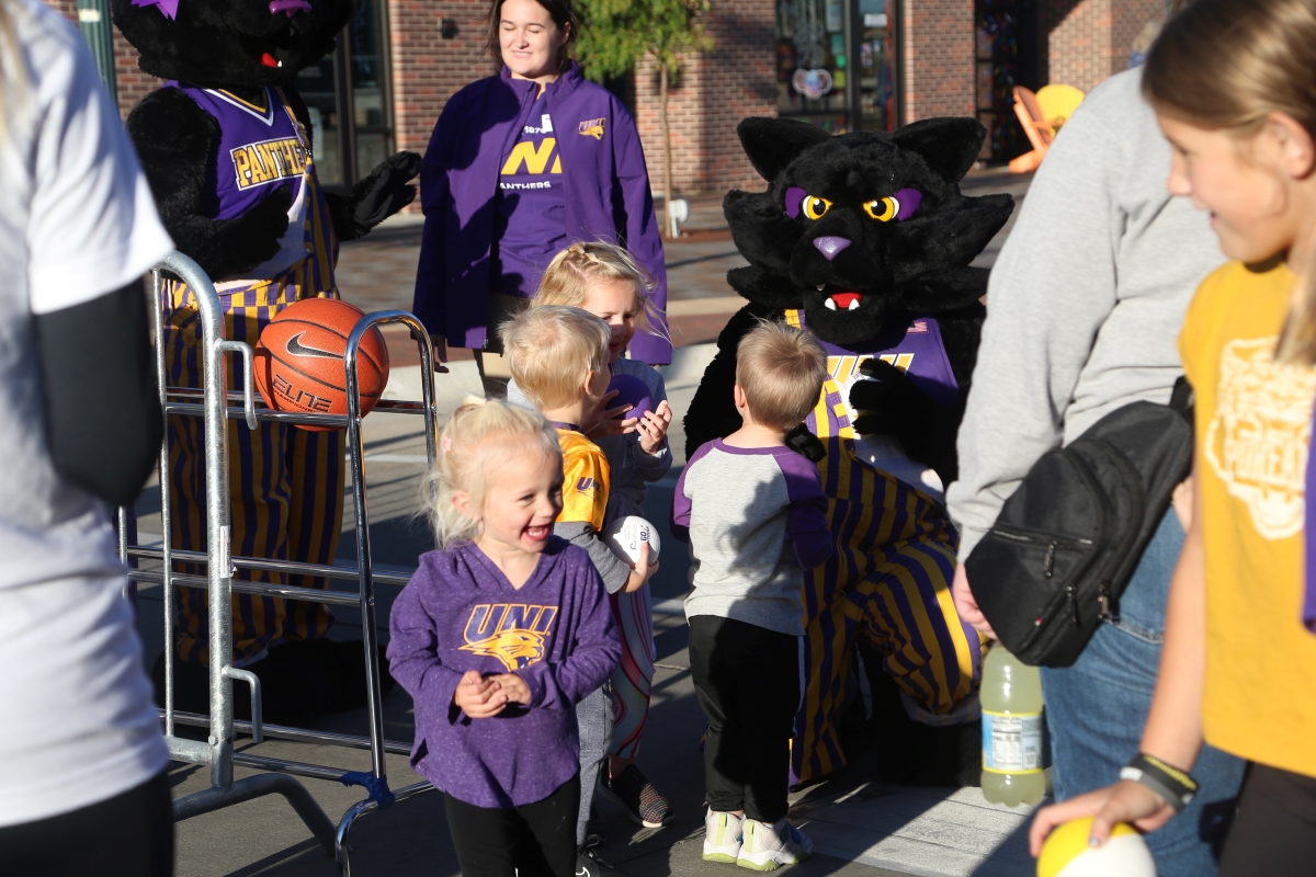 TC mascot and children playing with basketballs