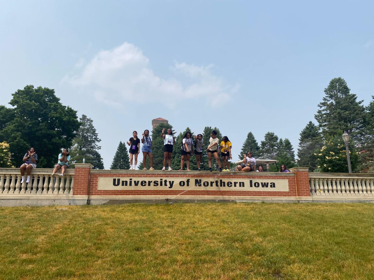Upward Bound Math and Science students standing on University of Northern Iowa sign on campus