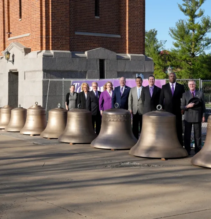 UNI senior leadership with bells in front of the Campanile in 2023