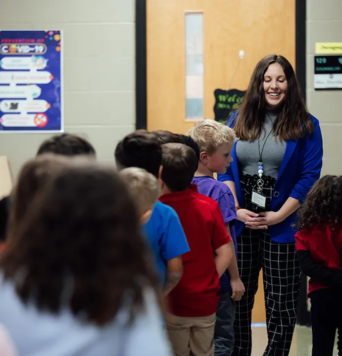 Teacher in front of line of students