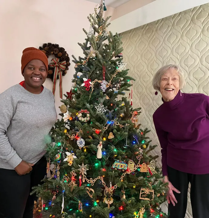 Plaxcedes Mawora and Margie Keiser with decorated Christmas tree