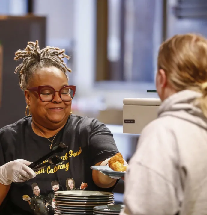 Entrepreneur serving food to student in Rialto
