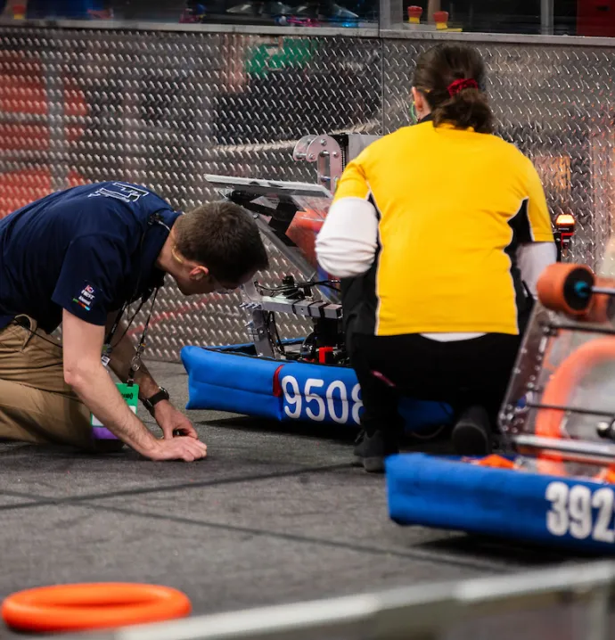 Students readying robots for competition 
