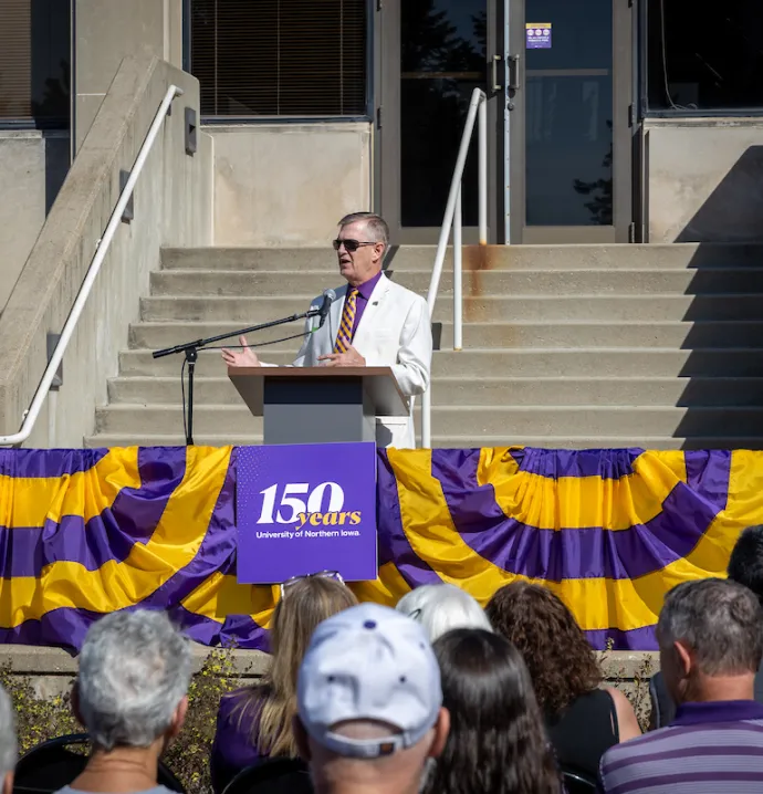 President Nook speaking at podium at sesquicentennial event