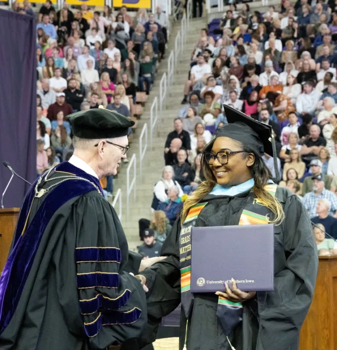 Sheritta Stokes shaking President Nook's hand at graduation