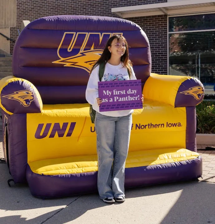 Student holding a "My first day as a Panther" sign