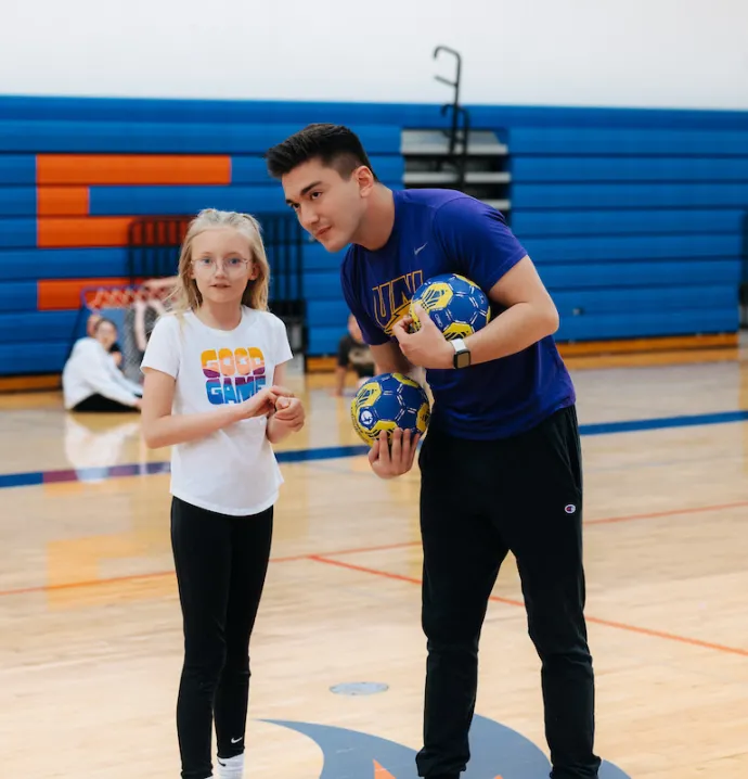 PE teacher working with student