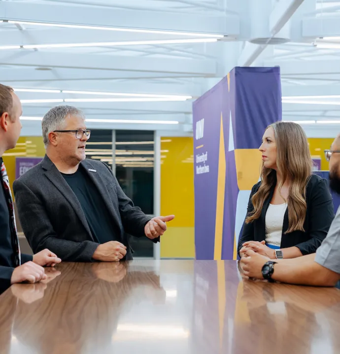 Doctorate students panel on a table with UNI faculty