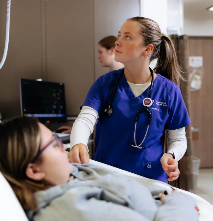 Nursing student working with patient during clinicals