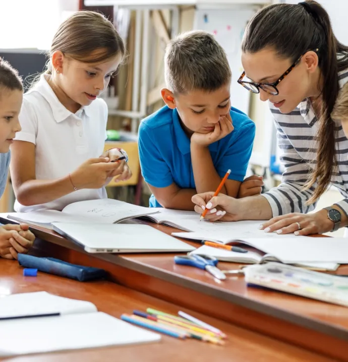 Teacher working with students