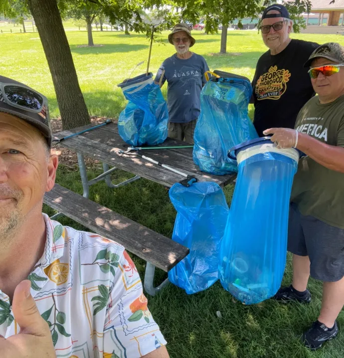 Men's Sheds participants cleaning up litter outside