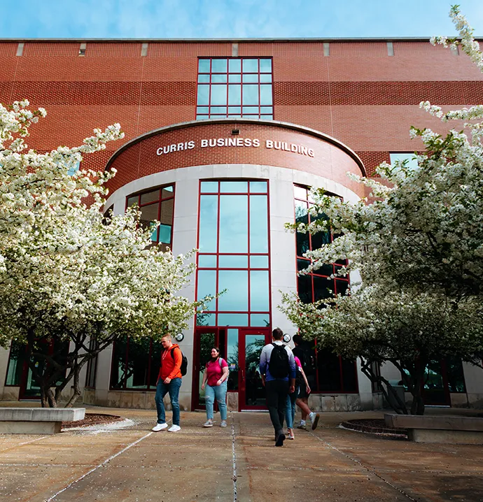 Students walking outside of Curris Business Building