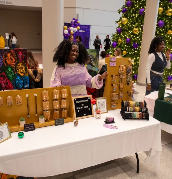 UNI student entrepreneur showing her jewelry off in the Gallagher