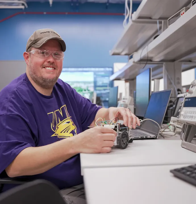 Jeremy Mescher working with robot