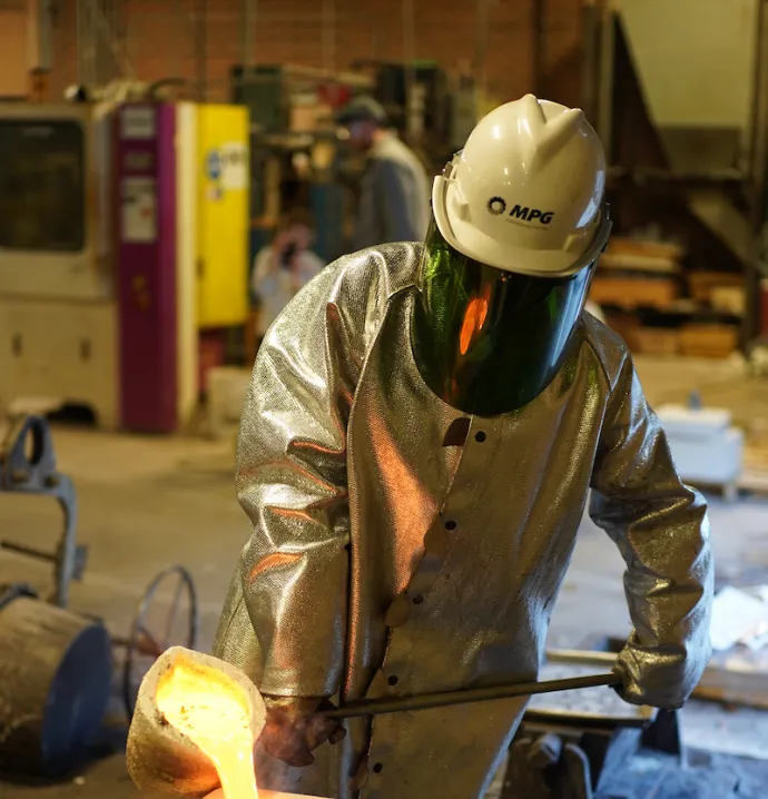 Student pouring molten metal in UNI Metal Casting Center
