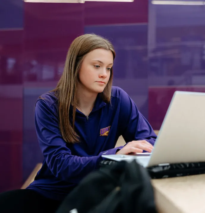 UNI student working on laptop