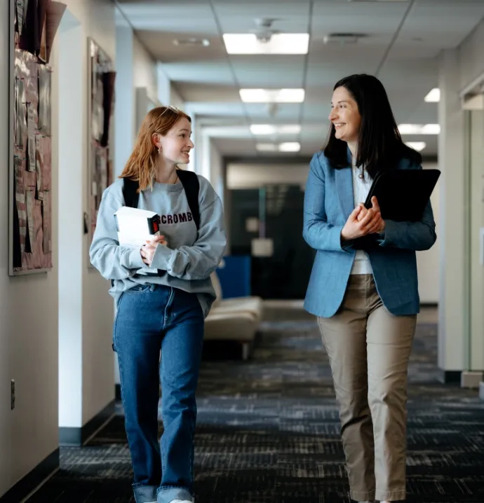 UNI professor and student walking in hallway