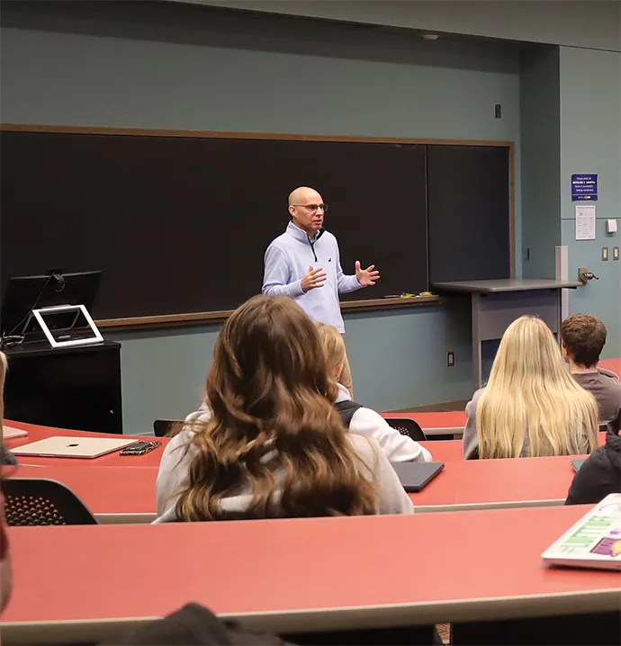 Nick Sars stands in front of ethics class